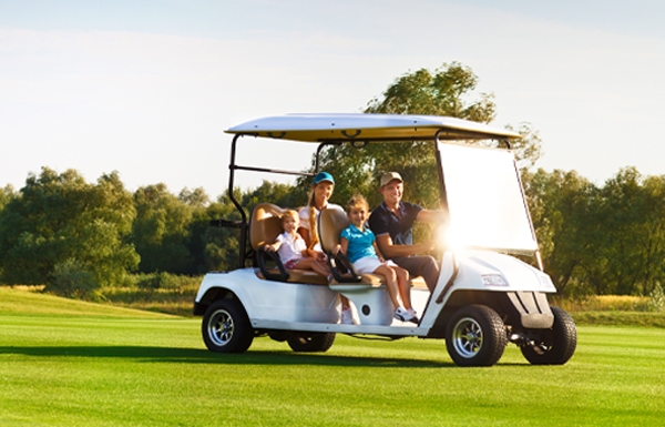 Players on golf cart